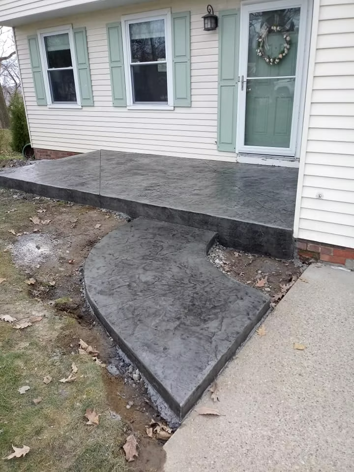 Broom finished concrete patio slab adjacent to a residential home