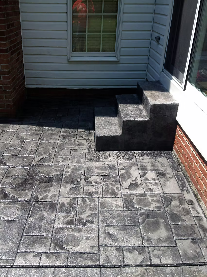 Large poured concrete patio with clean edges and smooth finish