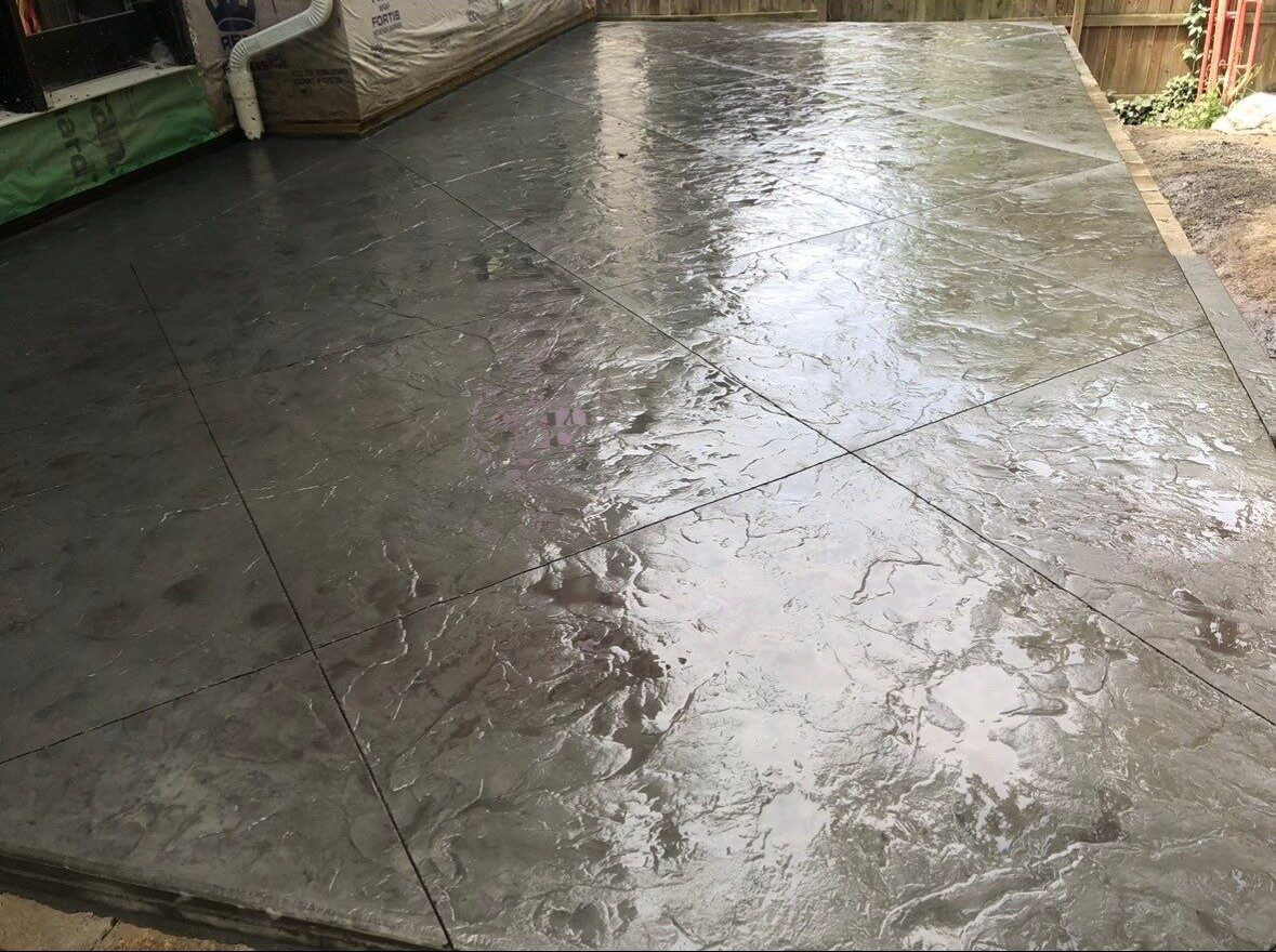 Clean poured concrete patio slab off the back of a home