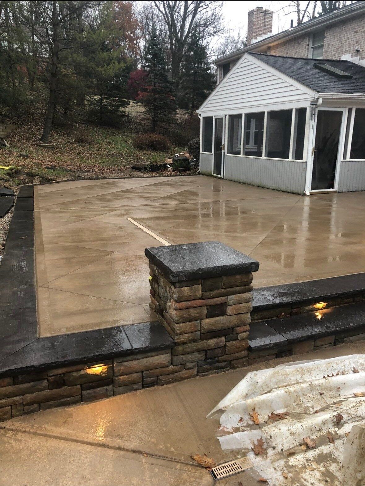 Concrete front steps and landing at a brick home