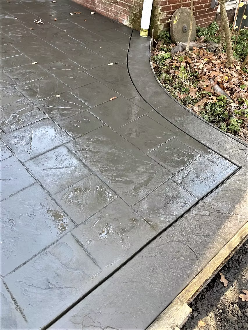 Concrete front steps and landing at a brick colonial home