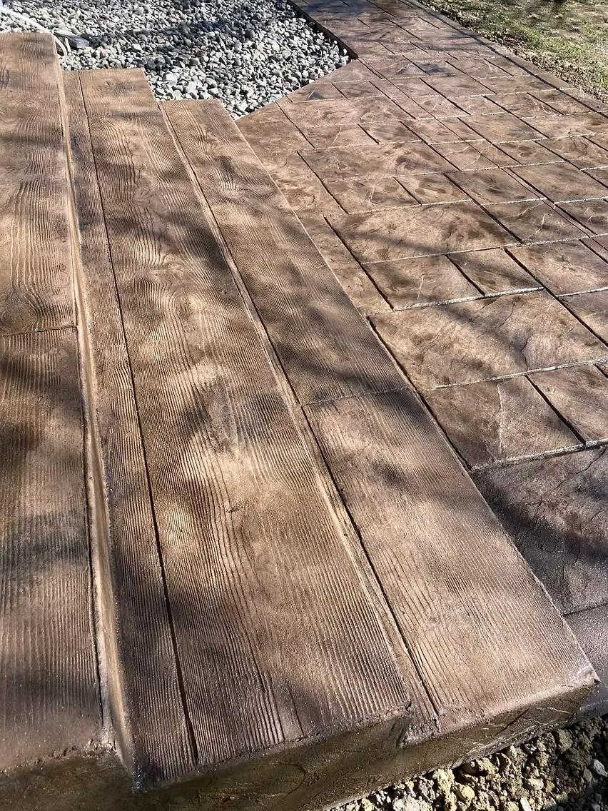 Broom finished concrete patio and walkway at rear of home