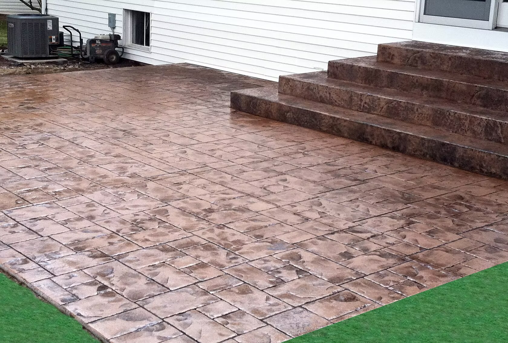 Stamped concrete patio with stone pattern and antiquing color